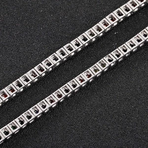 Macro shot of colorful square-cut zircon tennis chain with silver prong setting detail