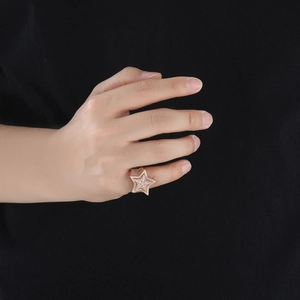 Macro shot of rose gold hip hop star ring with iced out pavé cubic zirconia details