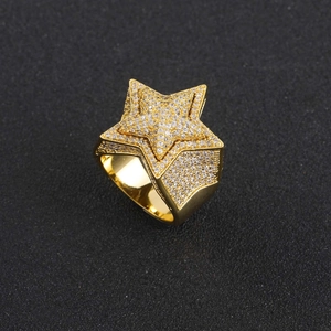 Macro detail of gold plated star ring featuring micro-paved cubic zirconia stones