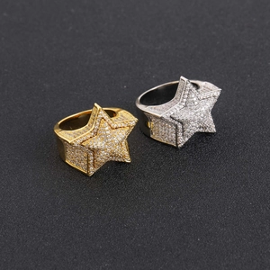 Macro detail of gold and silver hip hop star rings with full micro pave zircon stones