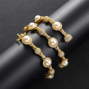 Detailed macro view of hip hop gold chain with pearls and paved diamonds