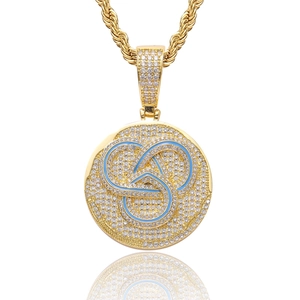 Detailed macro view of hip hop coin pendant with blue enamel and pavé-set zircon stones
