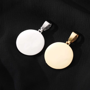 Polished gold and silver disc pendants with high-shine mirror finish on black fabric