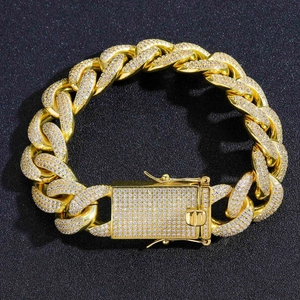 Macro shot of gold hip hop Cuban chain links with white pavé cubic zirconia details