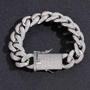 Detailed macro view of 18mm silver Cuban link chain with pave set zircons and box clasp