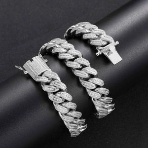 Macro detail of 18mm Cuban link necklace with micro-paved baguette zircons