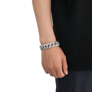 Close-up of 18mm Cuban link chain with triple rows of zircon stones on male model
