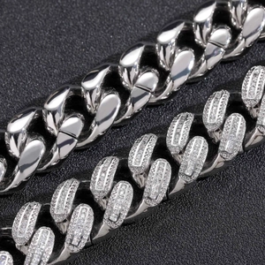 Macro detail of polished and diamond-encrusted 18mm Cuban link chains in hip-hop style