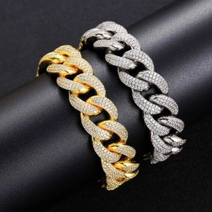 Close-up of 18mm gold and silver Cuban link chains with iced-out micro-pave zircons