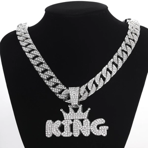 Silver-toned iced out KING crown pendant on a Cuban link chain necklace for men