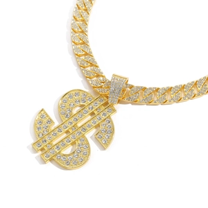 Macro shot of hip hop gold Cuban chain with large iced-out dollar sign pendant