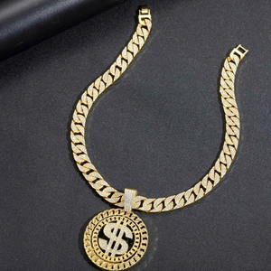 Detail of hip hop Cuban link chain with a large iced-out dollar sign round pendant