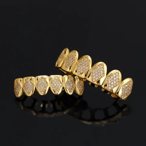 Hip hop gold grillz set with micro-paved cubic zirconia stones on black background
