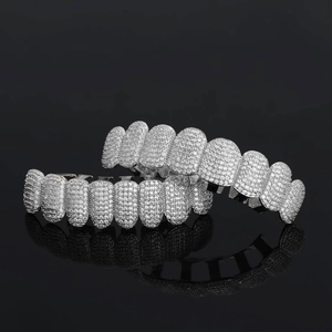 Silver color hip hop grillz set with pavé-set clear zircons on black reflective background