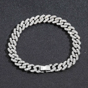 Macro shot of 9mm silver iced out Cuban link bracelet with sparkling handset rhinestones