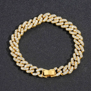 Macro shot of 9mm gold-plated iced out Cuban link chain with sparkling white rhinestones