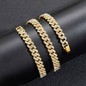 Macro shot of 9mm gold Cuban link necklace with dense zircon pavé and secure clasp