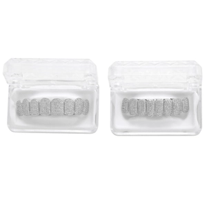 Close-up of iced out hip hop grillz set with clear cubic zirconia in display cases