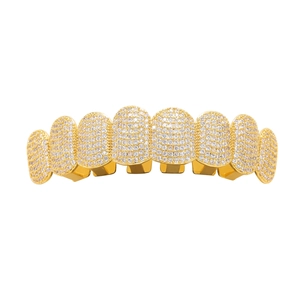 Close-up of gold-plated iced out grillz with micro-pave zirconia stones and metal slots