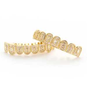 Macro shot of gold-plated hip hop grillz set with baguette and round cubic zirconia