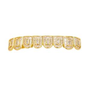Macro shot of gold hip hop grillz with eight teeth paved in shiny square zircon stones