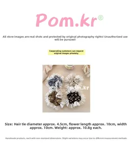 Detail of floral scrunchies with white lace edges in blue, beige, and black fabric