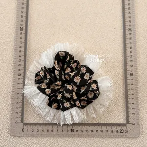 Floral fabric scrunchie with white lace trim and 13cm diameter measurement shown
