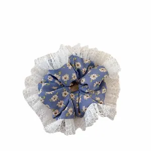 Navy floral hair scrunchie with white lace trim and yellow daisy print for girls