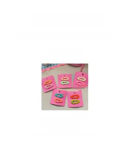 Detail showing wavy edge candy-colored hair clips with a matte finish for kids