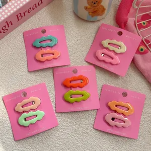 Colorful wavy candy-colored children hair clips on cardboards in various bright summer shades