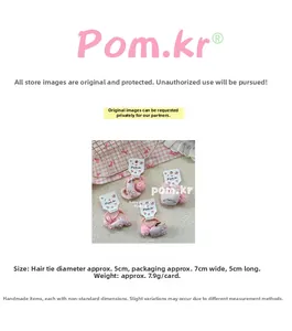 Detail view of pink hair ties with cartoon embroidery and 5cm diameter specification