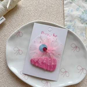 Close-up of sweet pink bow hair clip and BB clip set on white display cardboard