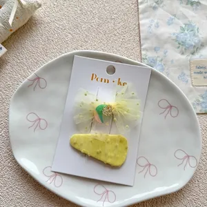 Detailed shot of yellow polka dot mesh bow hairpins on a decorative white plate
