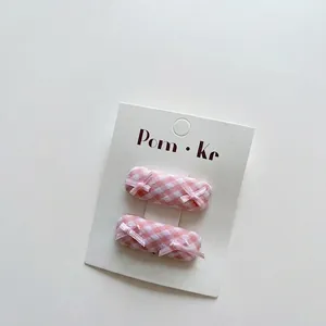 Pink and white plaid bow hair clips for girls set on white display card