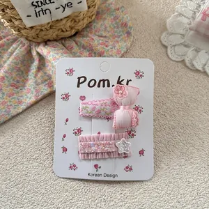 Detail of pink bow hair clips with floral beads and sequins on decorative card