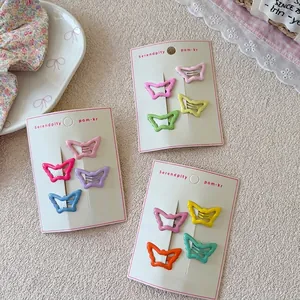 Set of 4 colorful butterfly-shaped hollow metal hair clips in sweet candy colors