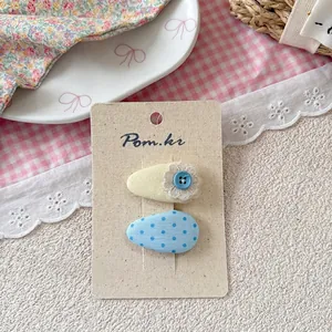 Close-up of sweet pastel fabric hair clips on a display card for girls and children