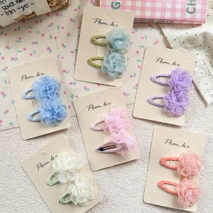 Floral hair clip set for girls with colorful layered fabric petals on fabric-wrapped clips
