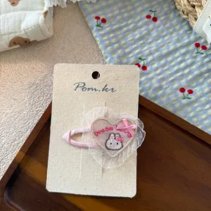 Close-up of pink heart lace hair clip featuring a cute bunny and Dream Bunny embroidery
