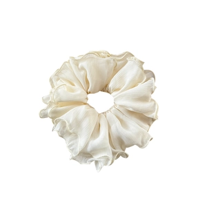 Elegant cream ruffled scrunchie with soft pleated chiffon fabric and dainty lettuce edges