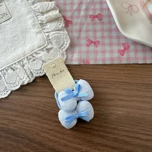Détail de chouchous nœuds à rayures bleues sur carte avec un fond floral doux et élégant