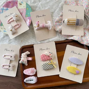 Kids hair clips set featuring fabric embroidered cats, pearls, and plaid bow designs