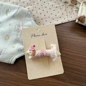Detail of handmade puppy embroidery hair clip with pink rose and delicate white lace