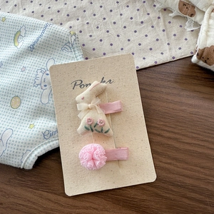Detail view of handmade fabric bow hair clip and pink tulle ball accessory set for girls