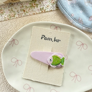 Detail of embroidered lavender fish hair clip for girls on elegant display card