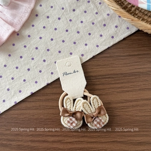 Close-up of rabbit embroidery and coffee satin bow on high-elasticity hair ties