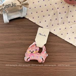 Detailed close-up of cute pink cat embroidery on a high-elastic fabric hair scrunchie