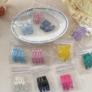 Detail of candy color metal snap hair clips set for girls in various pastel shades