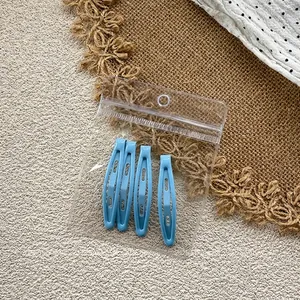 Set of four light blue teardrop hair clips for girls in a clear plastic bag