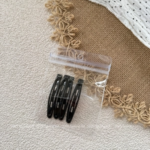 Set of 4 black metal teardrop hair clips in a clear hanging pouch for easy storage